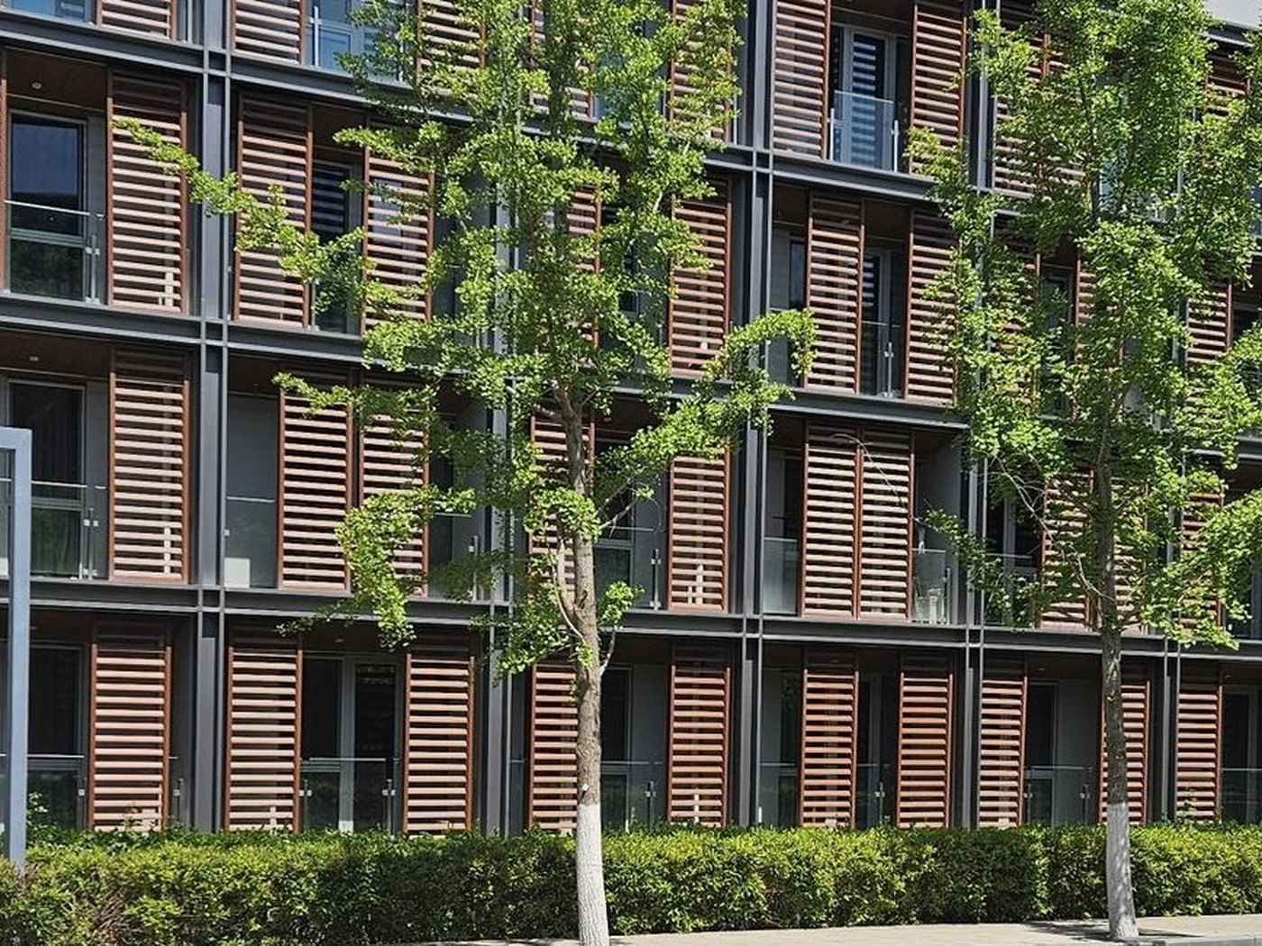 Modular apartment facade with timber louvre screens